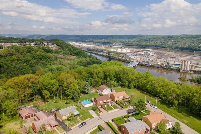 aerial overview of property's location with a nearby body of water and nearby suburban area