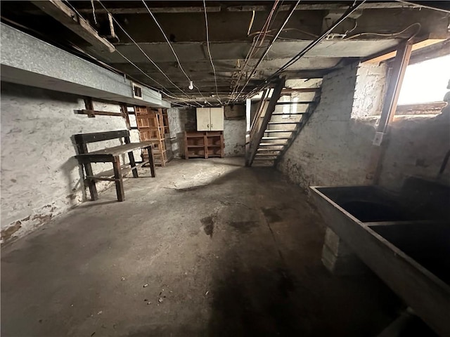 unfinished basement featuring stairway