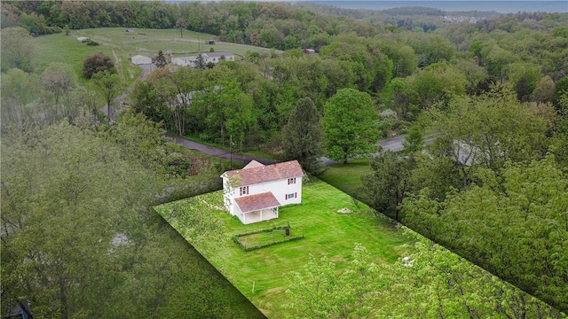 view from above of property with a heavily wooded area