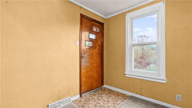 entryway with baseboards and ornamental molding