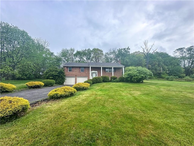 105 Audrey Ln, Jefferson Twp But, PA 16023 - bi-level home with asphalt driveway, a chimney, a front yard, and brick siding