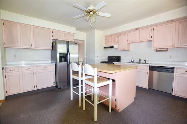 105 Audrey Ln, Jefferson Twp But, PA 16023 - kitchen with stainless steel appliances, under cabinet range hood, a sink, backsplash, and ceiling fan