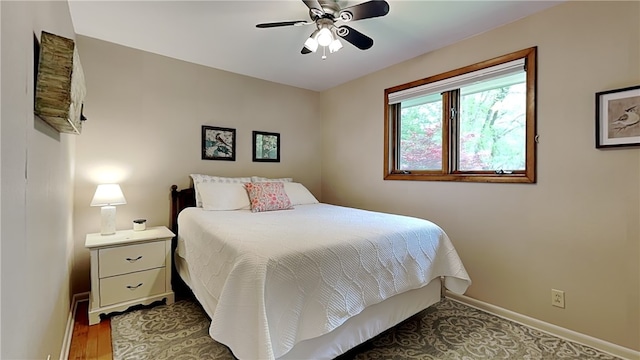bedroom with baseboards and a ceiling fan