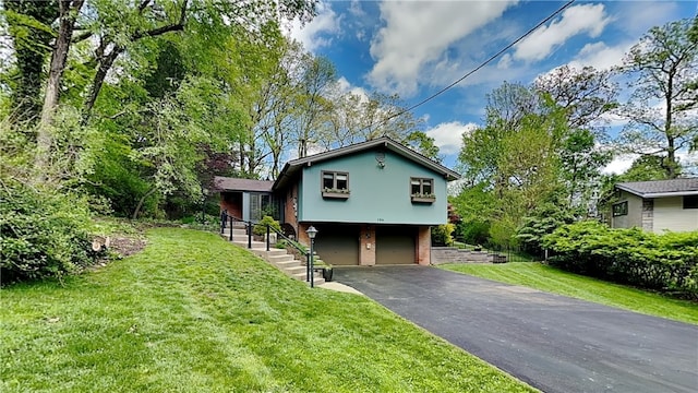 view of front of house with asphalt driveway, an attached garage, and a front lawn
