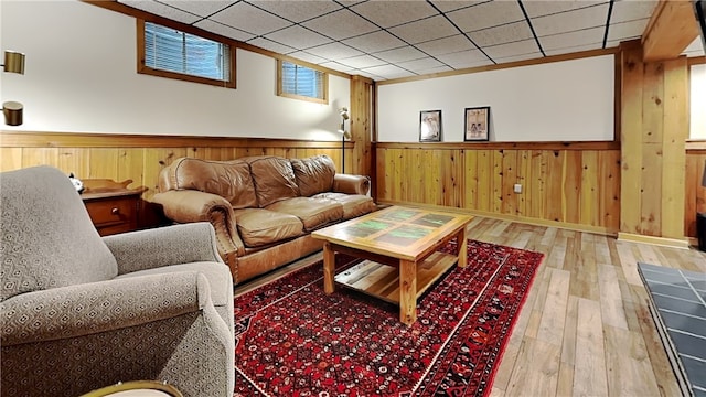 living room with hardwood / wood-style floors, a wainscoted wall, and wood walls