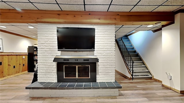 unfurnished living room with wood finished floors, baseboards, wainscoting, stairway, and recessed lighting