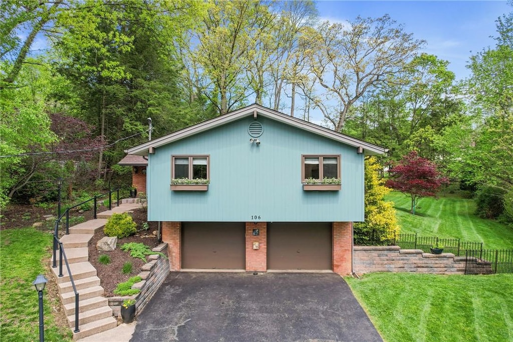 106 Country Ln, Ross Twp, PA 15229 - view of front of house with asphalt driveway, a garage, brick siding, and stairs