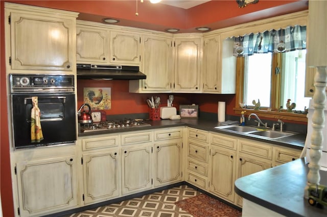 3344 Orangeville Rd, South Pymatuning Twp, PA 16150 - kitchen with oven, under cabinet range hood, stainless steel gas cooktop, dark countertops, and a sink