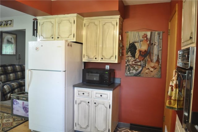 3344 Orangeville Rd, South Pymatuning Twp, PA 16150 - kitchen with freestanding refrigerator, black microwave, wall oven, and dark countertops