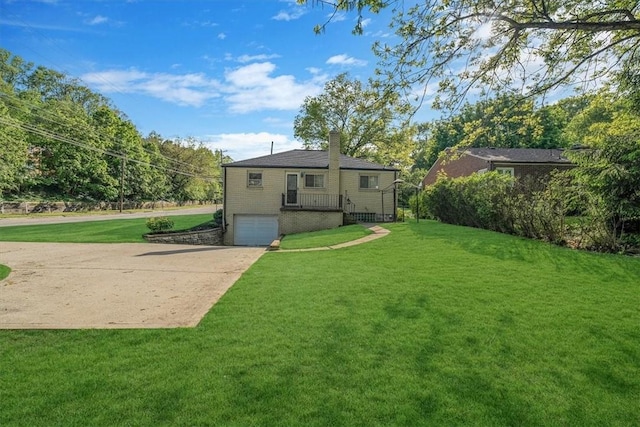 417 Orchard Dr, Mt Lebanon, PA 15228 - back of house with an attached garage, driveway, a chimney, brick siding, and a lawn