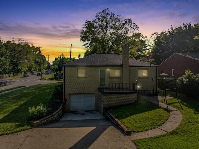 417 Orchard Dr, Mt Lebanon, PA 15228 - view of front of property with driveway, a garage, brick siding, a chimney, and a yard