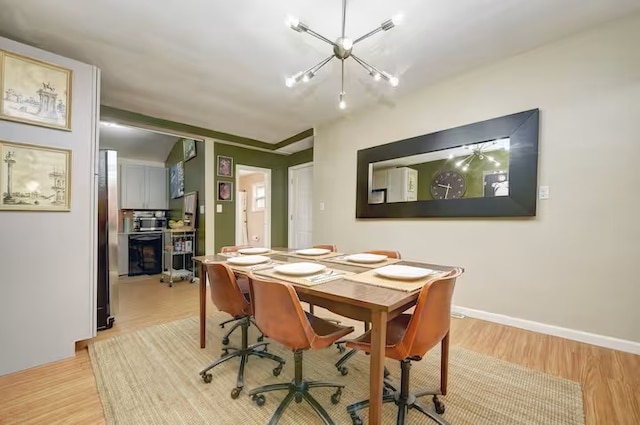 185 42nd St, Lawrenceville, PA 15201 - dining room with a chandelier, wood finished floors, and baseboards