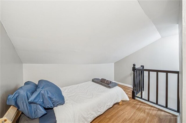 185 42nd St, Lawrenceville, PA 15201 - bedroom featuring lofted ceiling, wood finished floors, and baseboards