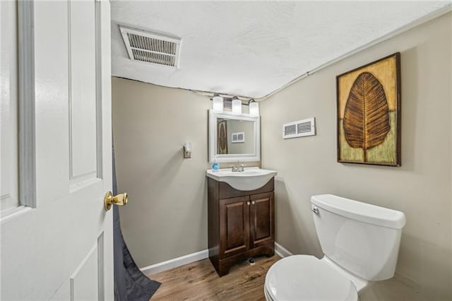 185 42nd St, Lawrenceville, PA 15201 - bathroom with wood finished floors, toilet, baseboards, and vanity