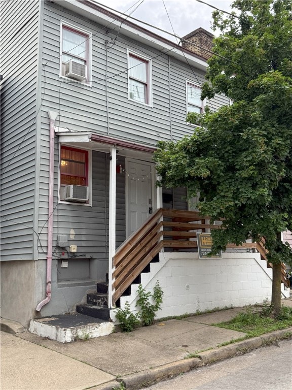 185 42nd St, Lawrenceville, PA 15201 - view of front facade with a chimney and cooling unit