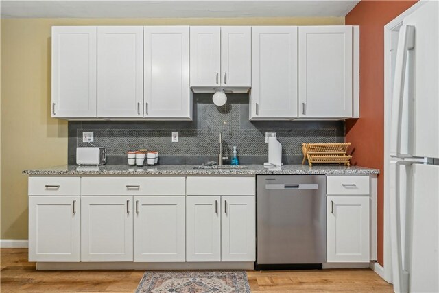 1851/2 42nd St, Lawrenceville, PA 15201 - kitchen featuring stainless steel dishwasher, freestanding refrigerator, a sink, and decorative backsplash
