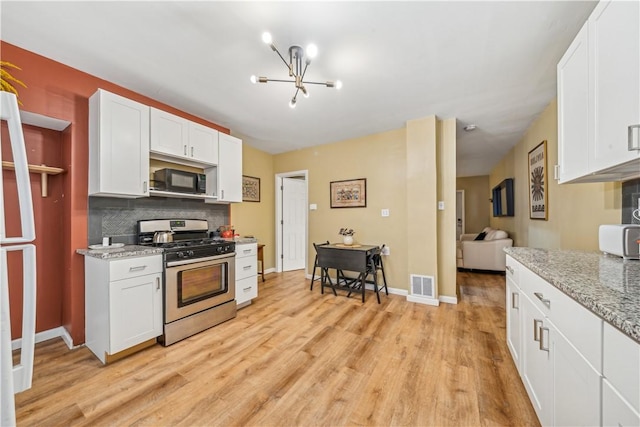 1851/2 42nd St, Lawrenceville, PA 15201 - kitchen with stainless steel gas range oven, black microwave, a chandelier, light wood-style floors, and white cabinets