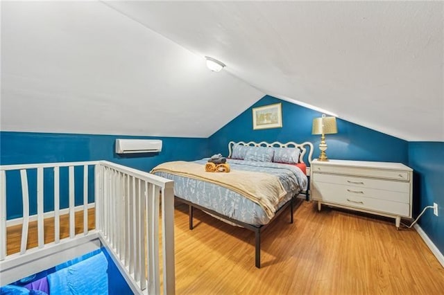 1851/2 42nd St, Lawrenceville, PA 15201 - bedroom featuring a wall mounted AC, wood finished floors, lofted ceiling, and baseboards