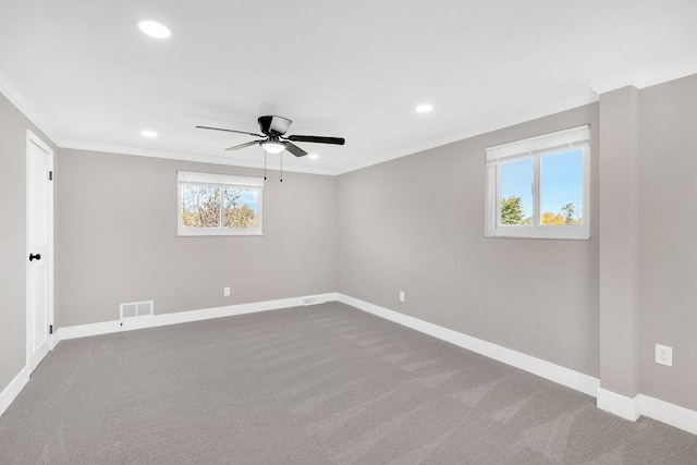 carpeted empty room featuring a ceiling fan, baseboards, recessed lighting, and crown molding