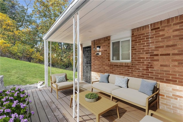 wooden terrace featuring outdoor lounge area and a lawn