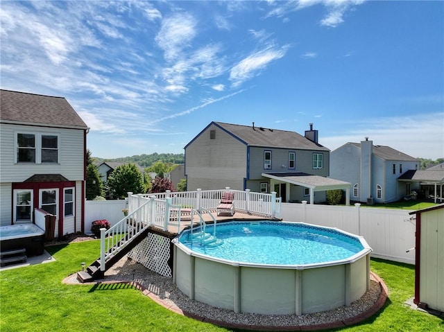 view of pool with a wooden deck and a residential view