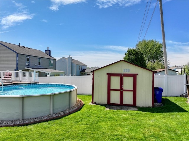 view of pool with a storage shed and an outdoor structure