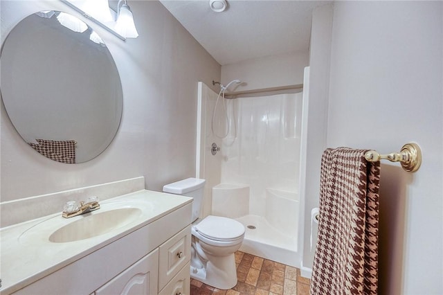 full bathroom featuring a shower, toilet, vanity, and stone finish flooring