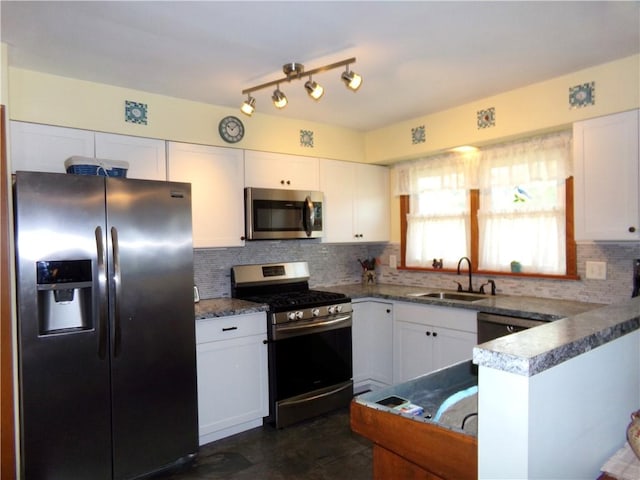 959 E Main St, Somerset Boro, PA 15501 - kitchen featuring appliances with stainless steel finishes, a sink, white cabinetry, and backsplash