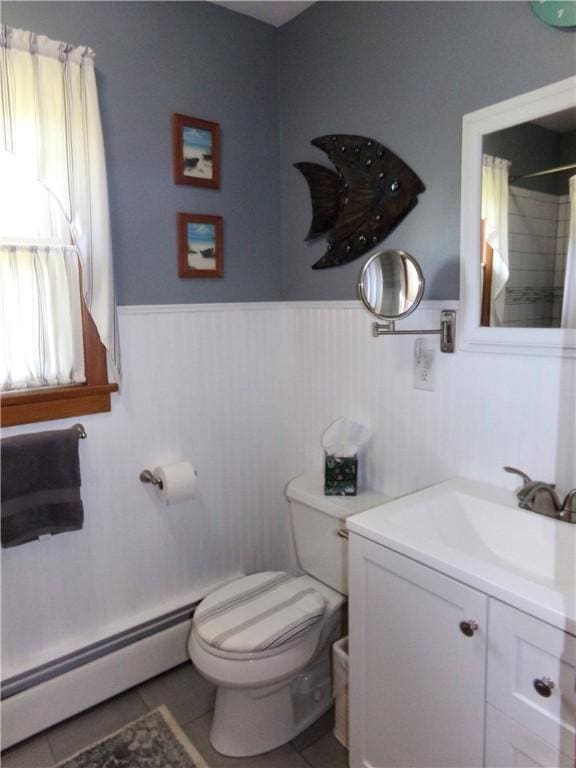959 E Main St, Somerset Boro, PA 15501 - full bath with a baseboard heating unit, wainscoting, toilet, vanity, and tile patterned floors