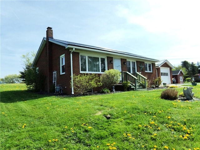 959 E Main St, Somerset Boro, PA 15501 - ranch-style home with a chimney, brick siding, a front yard, and a garage