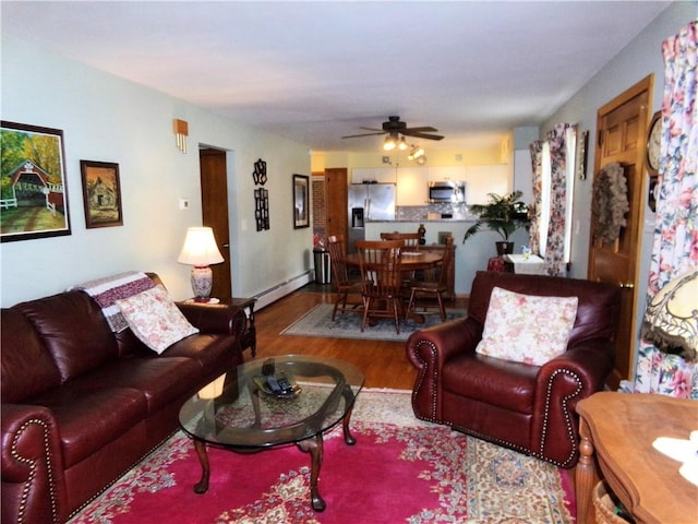 959 E Main St, Somerset Boro, PA 15501 - living area featuring wood finished floors, a baseboard heating unit, and ceiling fan