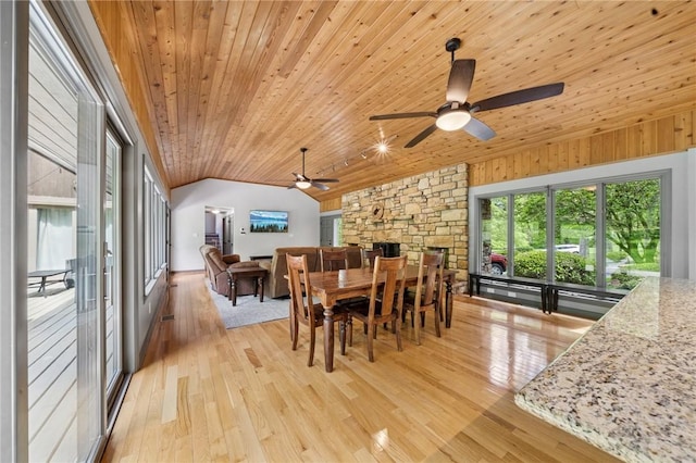 dining room featuring wooden ceiling, vaulted ceiling, light wood finished floors, and a ceiling fan