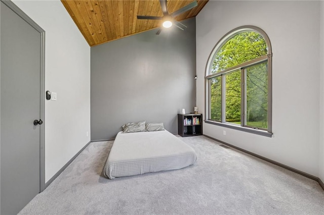 carpeted bedroom with wood ceiling, multiple windows, vaulted ceiling, baseboards, and a ceiling fan