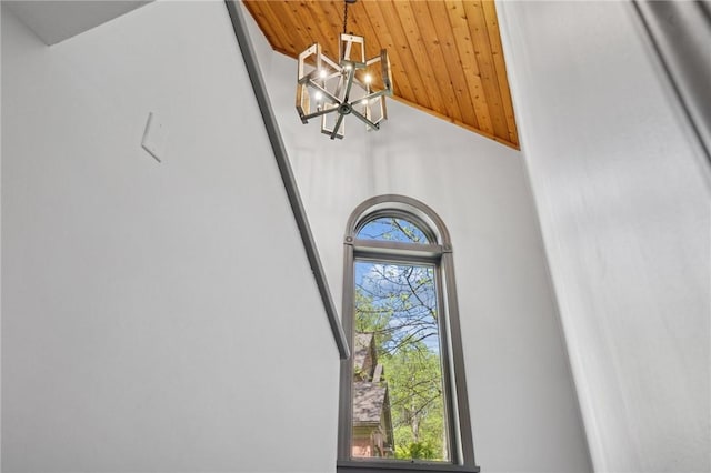 detailed view of a chandelier and wooden ceiling