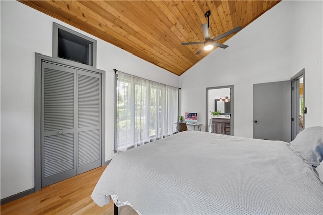 bedroom with wooden ceiling, wood finished floors, high vaulted ceiling, a ceiling fan, and ensuite bath