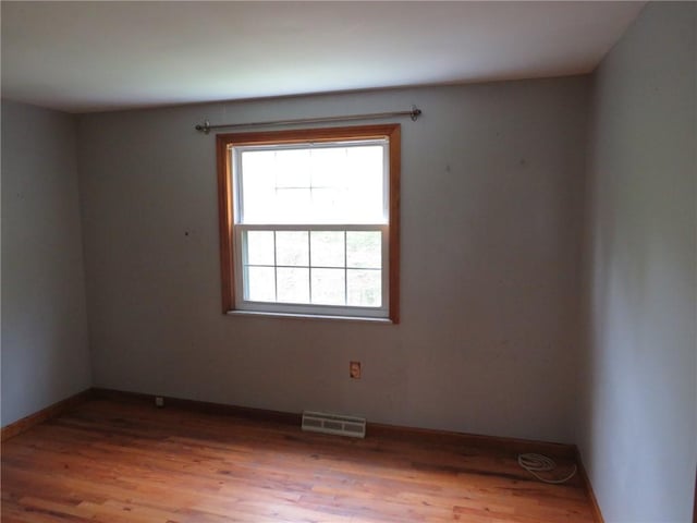 unfurnished room featuring wood finished floors and baseboards
