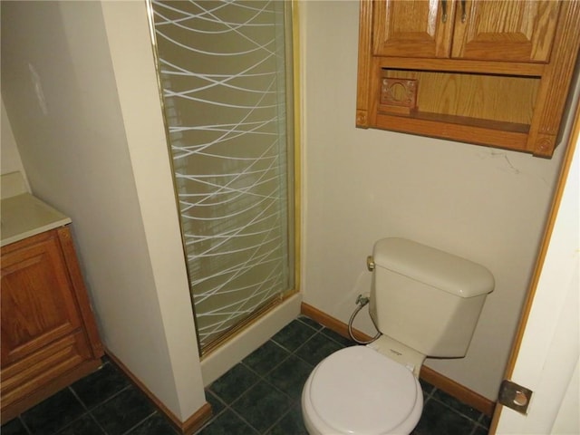 full bath with baseboards, a stall shower, toilet, and vanity