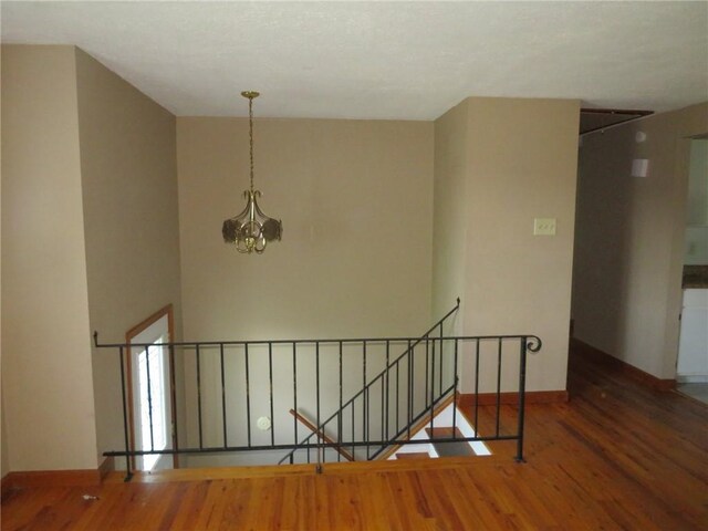973 Glen Hayes Dr, Moon/Crescent Twp, PA 15046 - staircase with a chandelier, wood finished floors, and baseboards