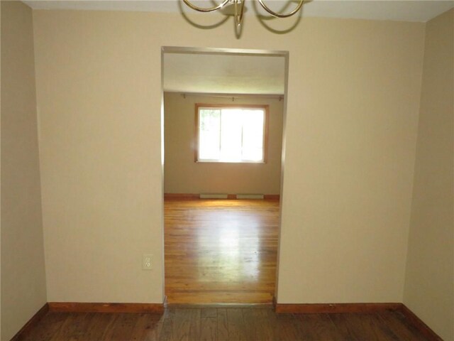 973 Glen Hayes Dr, Moon/Crescent Twp, PA 15046 - empty room featuring wood finished floors, a chandelier, and baseboards