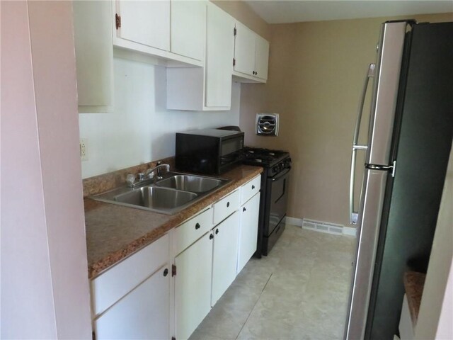 973 Glen Hayes Dr, Moon/Crescent Twp, PA 15046 - kitchen featuring black appliances, a sink, white cabinets, and baseboards
