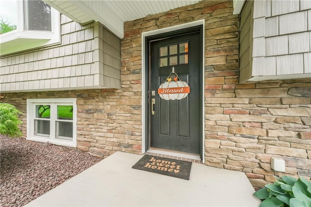 property entrance with stone siding and brick siding