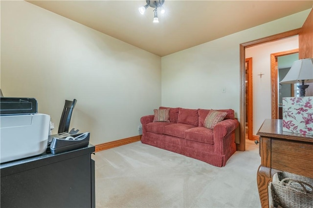 office area featuring light carpet and baseboards