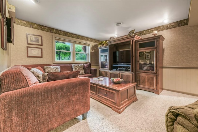 carpeted living area with wallpapered walls, a wainscoted wall, and wooden walls