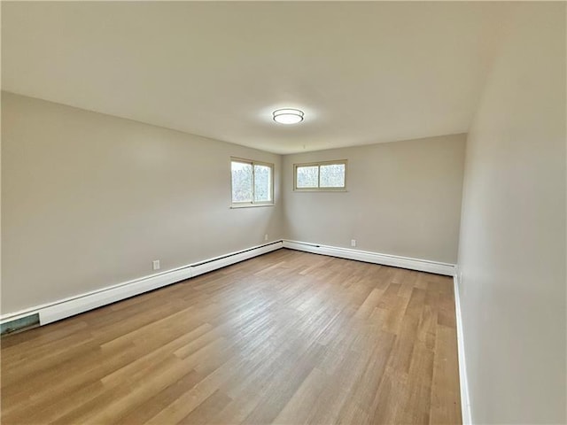spare room with wood finished floors and baseboards