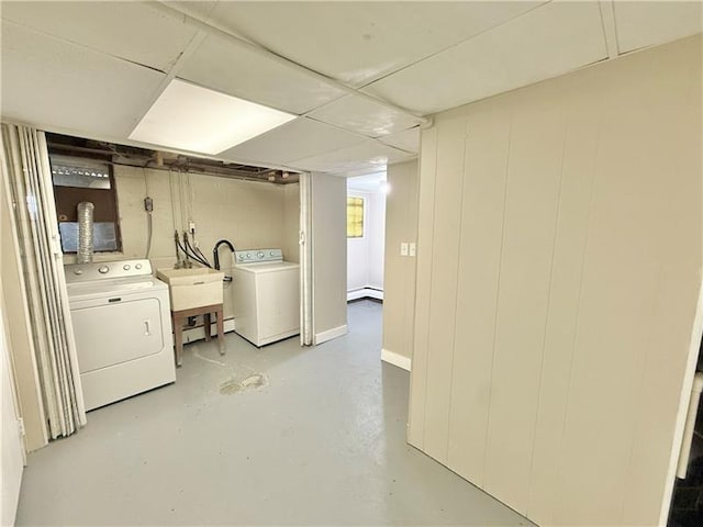 laundry room with washing machine and clothes dryer and a baseboard radiator