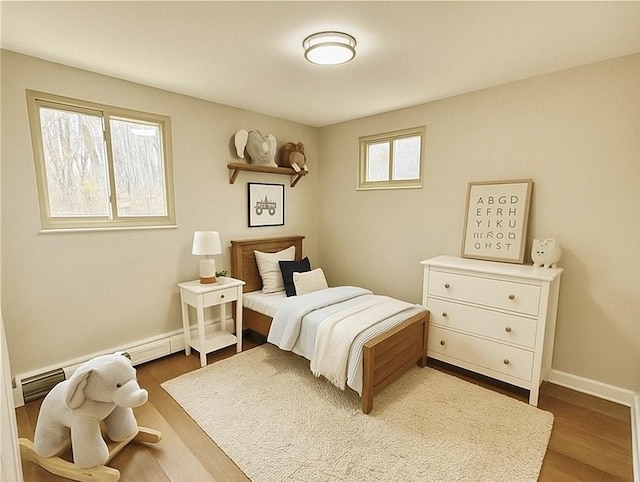 701 Mercer Rd, Twp Of But Nw, PA 16001 - bedroom with wood finished floors and a baseboard heating unit