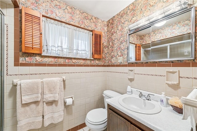 741 Whitehead Ln, North Huntingdon, PA 15642 - full bathroom with wallpapered walls, wainscoting, toilet, tile walls, and a shower with shower door