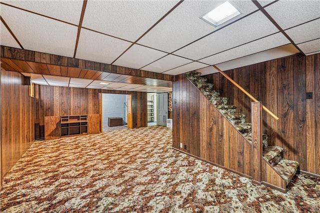 741 Whitehead Ln, North Huntingdon, PA 15642 - finished below grade area with wood walls, carpet floors, stairs, and a paneled ceiling