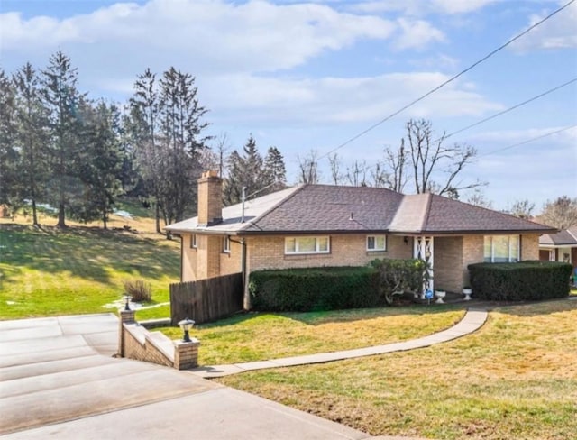 741 Whitehead Ln, North Huntingdon, PA 15642 - view of front facade featuring a chimney, a front yard, and brick siding