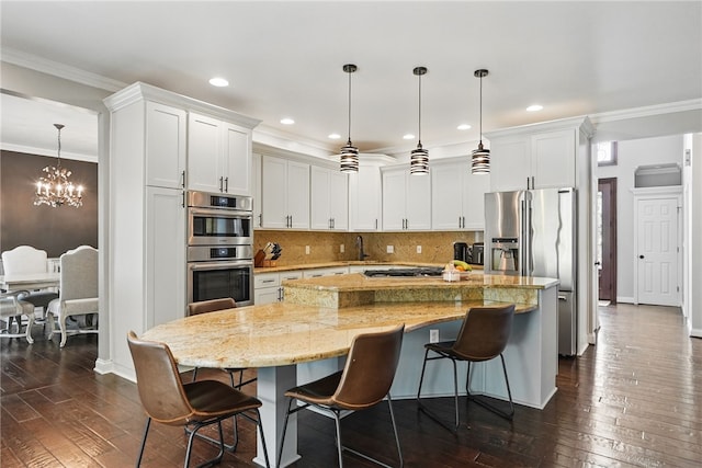 104 Ross Creek Ln, Peters Twp, PA 15367 - kitchen with appliances with stainless steel finishes, dark wood finished floors, a chandelier, a kitchen island, and white cabinetry